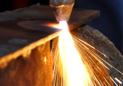 A plasma cutter is seen cutting through metal. SMF offers Plasma Cutting in Springfield IL.