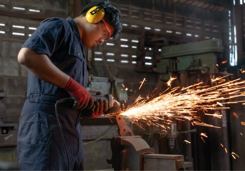 A metal worker is seen in a factory. SMF performs custom metal fabrication.
