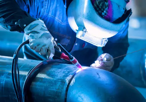 A welder is seen performing TIG welding. Is laser welding stronger than MIG or TIG welding? Call SMF.