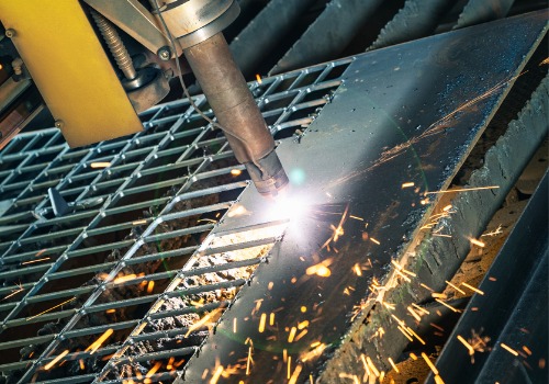 Sparks are seen flying from a plasma cutter. SMF offers metal cutting in Springfield IL.