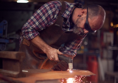 A plasma cutter is seen in use. SMF offers metal cutting in Illinois.