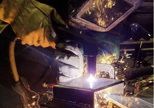 A worker is seen cutting metal. SMF offers Metal Cutting.