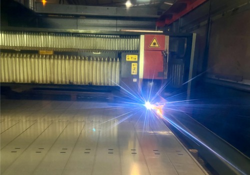 A laser cutter is seen in use. SMF offers metal cutting in Illinois.