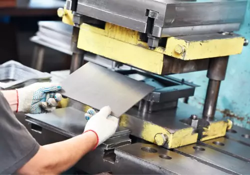 
A worker is seen handling sheet metal in a factory. SMF performs sheet metal fabrication in Charleston SC.
