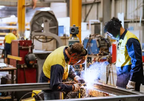 Metal workers are seen on the job. SMF performs Metal Fabrication for power generation.